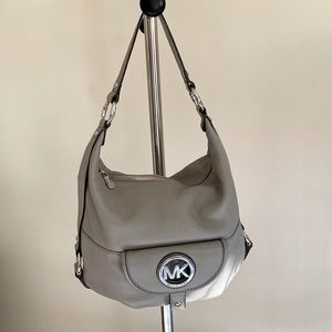 Michael Kors hobo style shoulder bag in light grey with silver hardware.